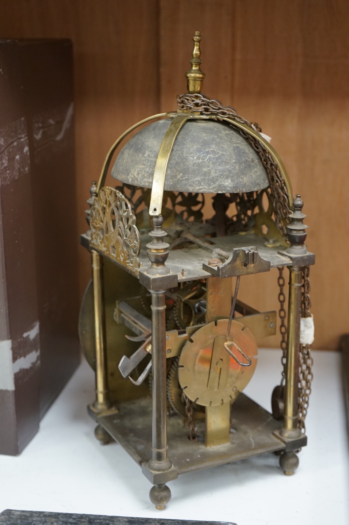 An 18th century lantern clock with pendulum and weight, the dial inscribed Philip Wardale, 37cm high